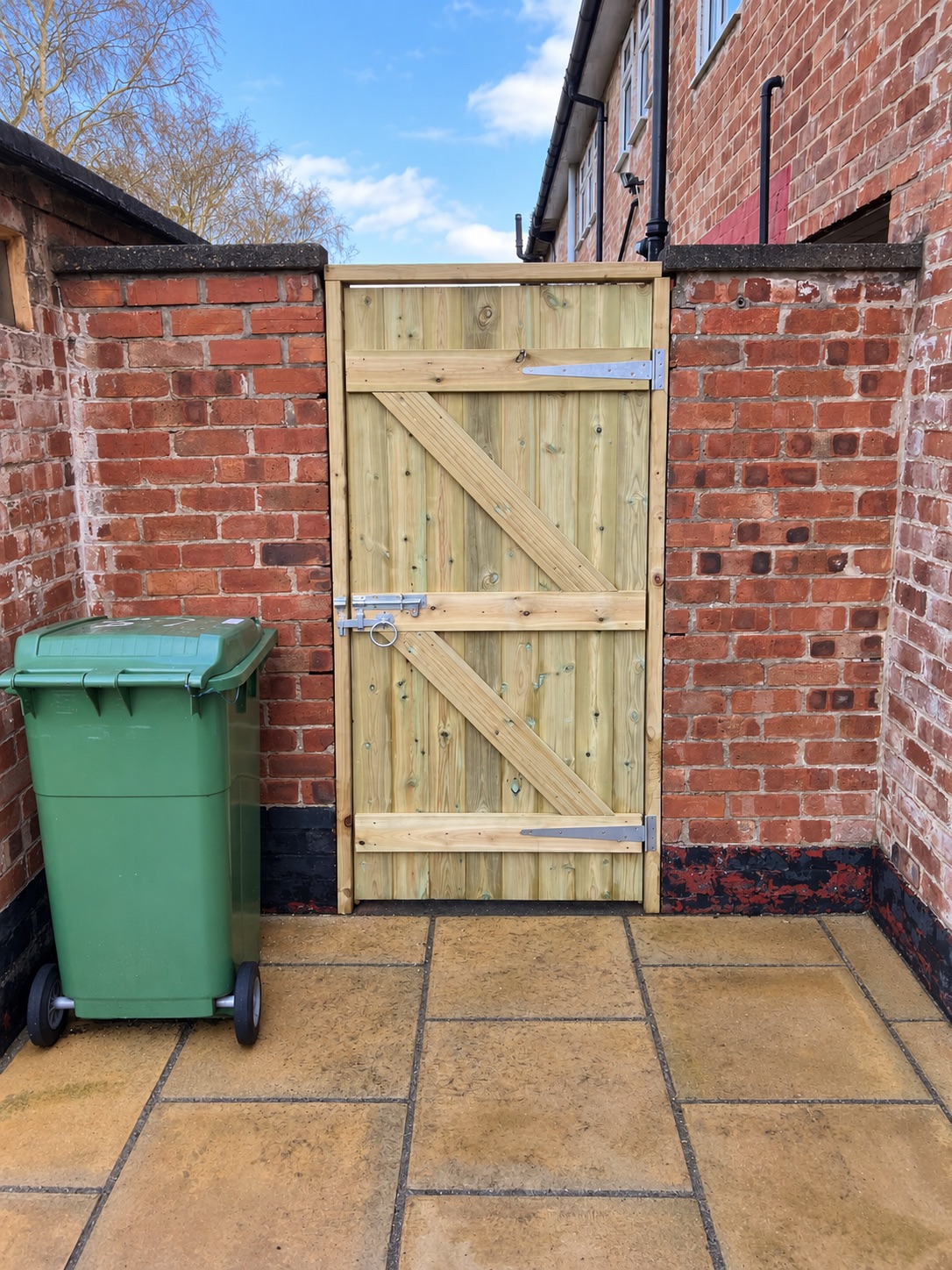 Traditional ledge and brace gate fitted in a brick terraced yard